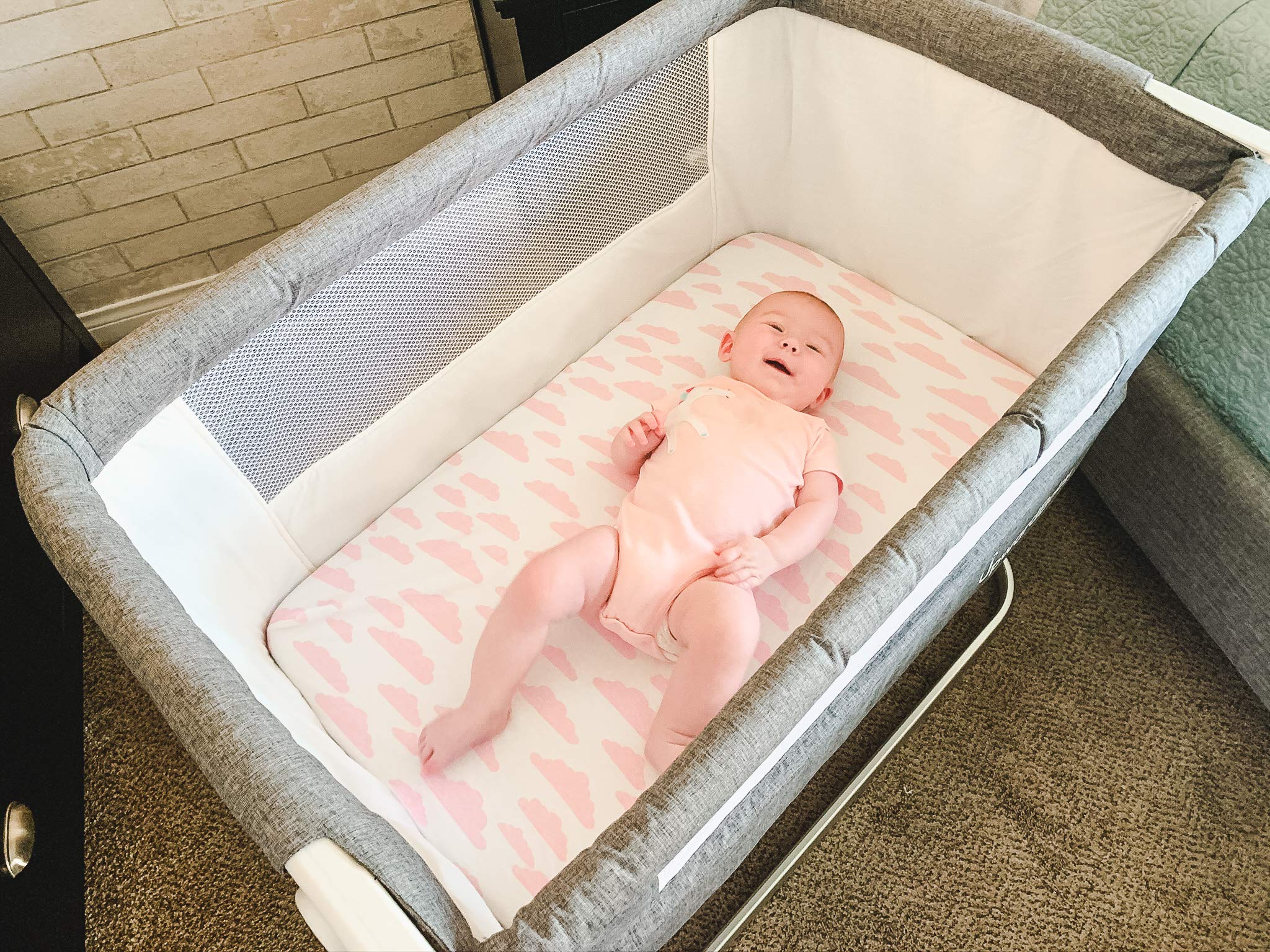 BaeBae Goods Elephants print sheet spread on a bassinet pad for cozy daytime naps.