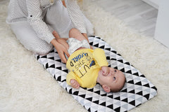 BaeBae Goods changing pad cover on a nursery changing pad during diaper changes—soft jersey fabric.