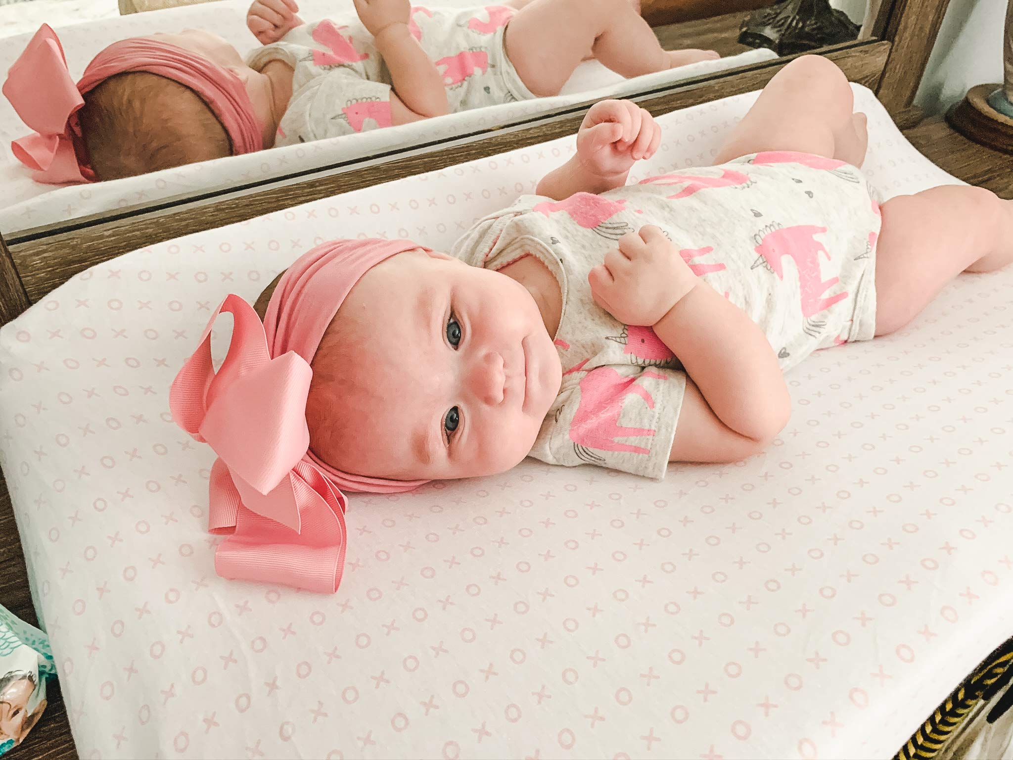 Baebae Goods changing pad cover elastic-fit on mat demonstrates secure, snug fit.