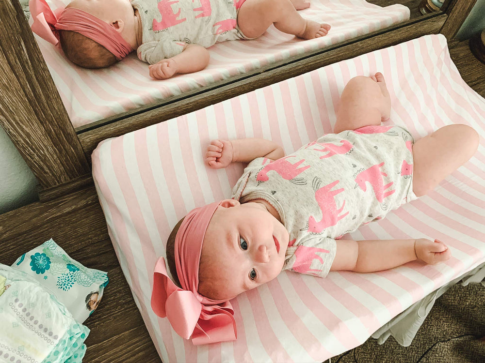 BaeBae Goods changing pad cover on mat demonstrates elasticized edge for secure changes.