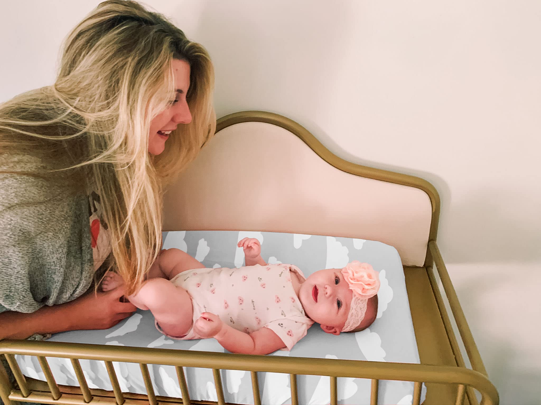 BaeBae Goods elasticated edge changing mat cover provides a secure fit during diaper changes.