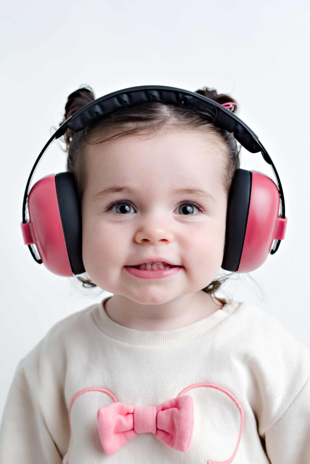 BANZ infant earmuffs maroon worn during travel for quiet, calm moments.