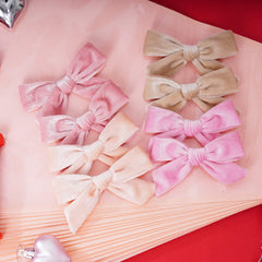 Baotongle velvet bow light pink close-up shows soft, luxe velvet texture and smooth edges.