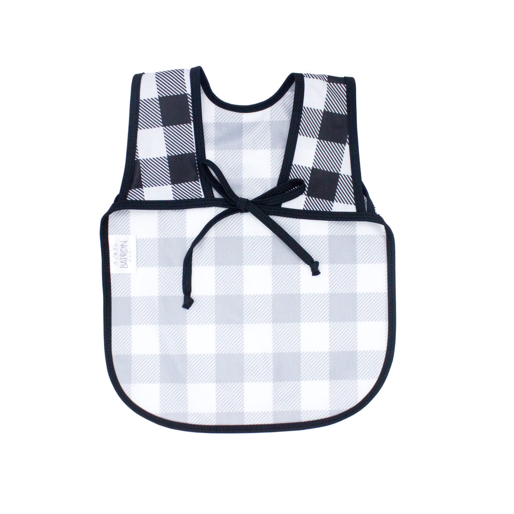 Close-up of fabric on BapronBaby white buffalo plaid bapron emphasizing quick-drying, stain-resistant material.