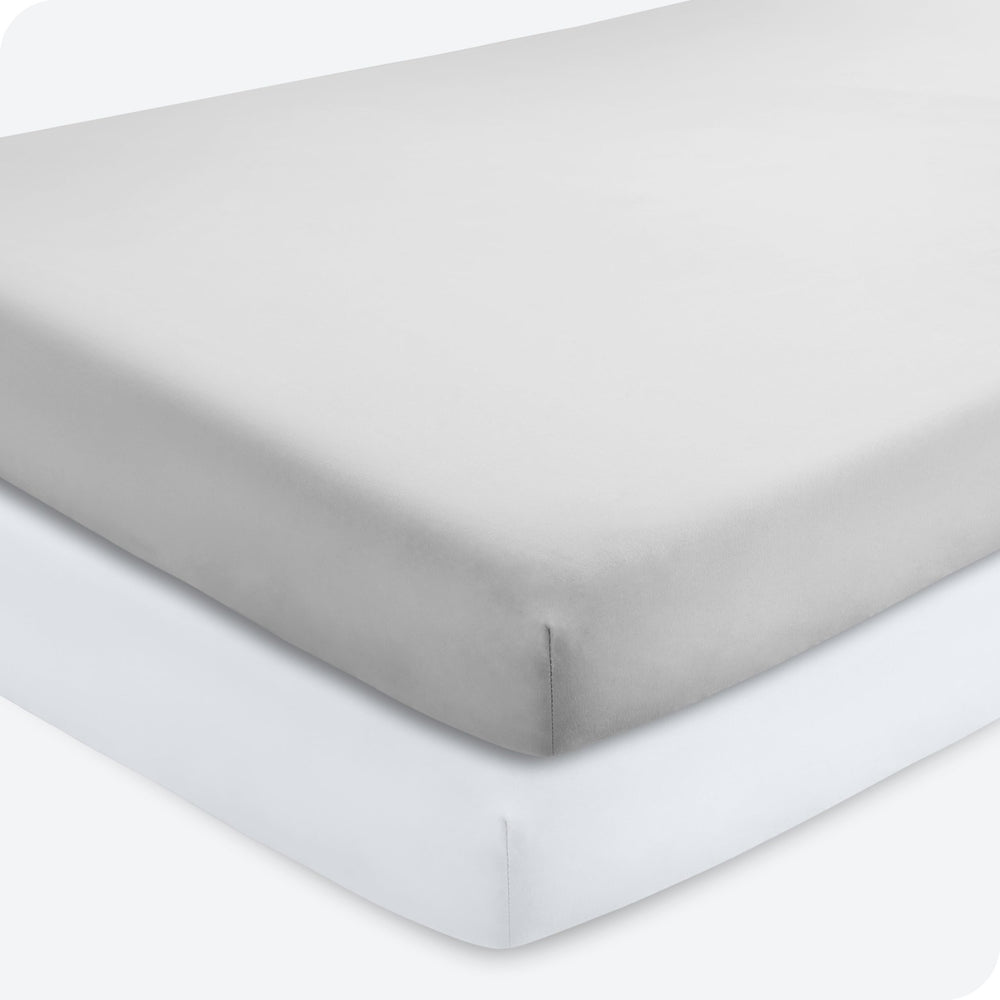 Bare Home 2-pack fitted crib sheets in cloud grey show elasticized stretch for snug crib fit.