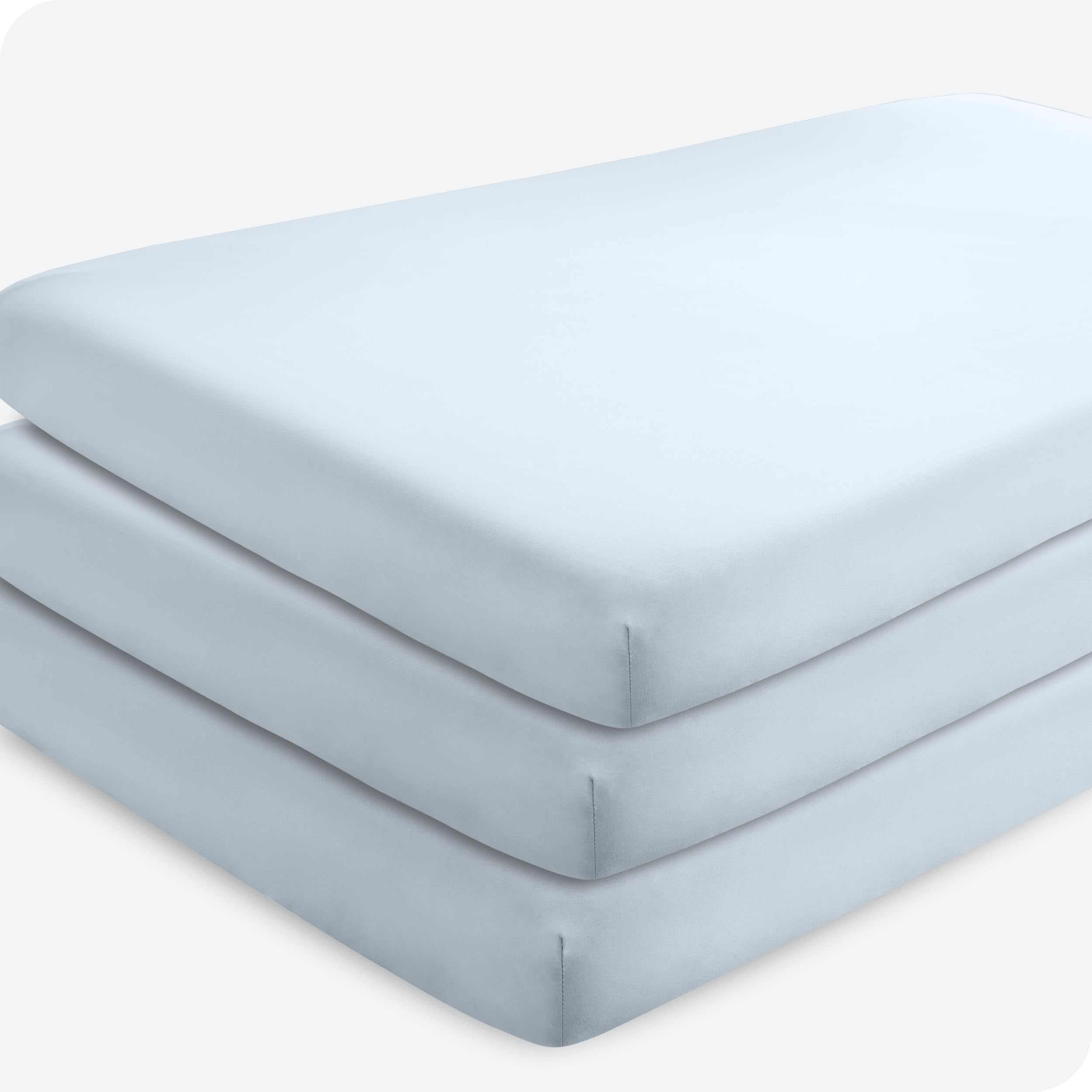 Bare Home sky-blue crib sheets in a flat lay show soft microfiber for gentle sleep.