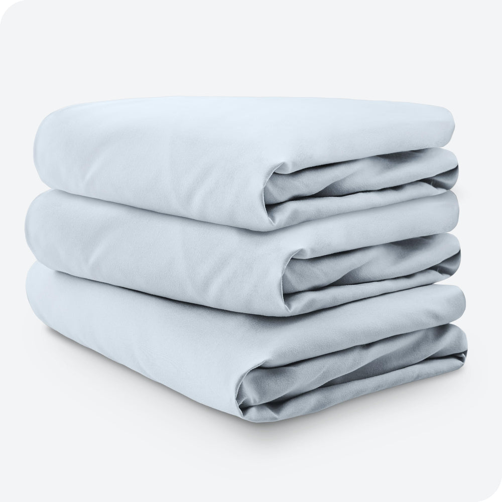 Bare Home sky-blue crib sheet on standard crib mattress ready for bedtime.