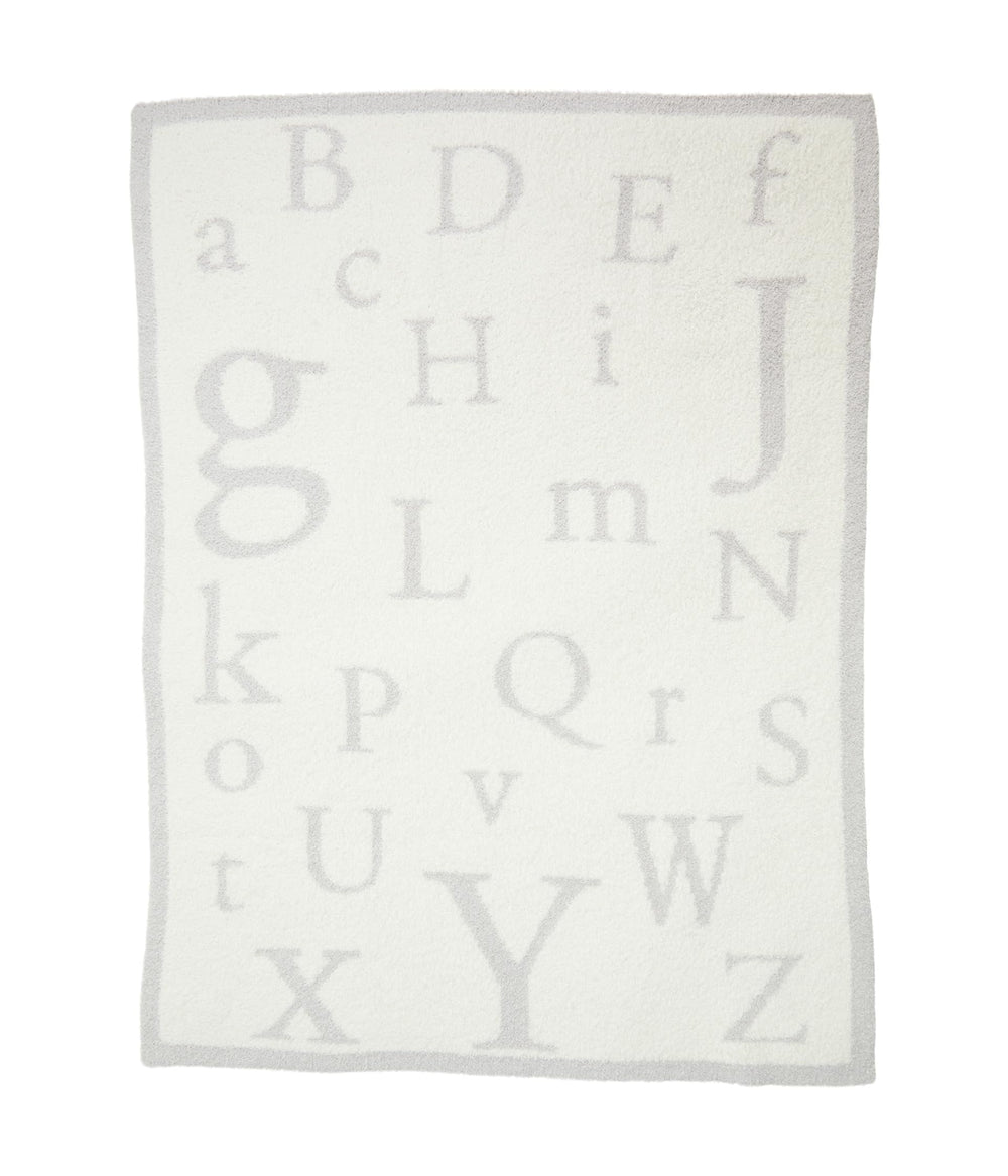 Barefoot Dreams CozyChic ABC Blanket cuddled by child during reading time.
