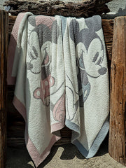 Barefoot Dreams CozyChic pink and white blanket highlighting soft hues for nap-time comfort.