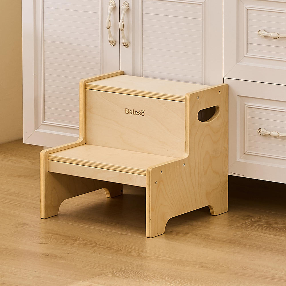 Bateso step stool near toilet supports potty training with sturdy wooden design