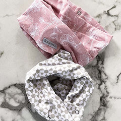 Bazzle Baby Bandobib adjustable snaps closeup for quick dressing.
