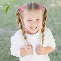 BBGifts baby hair ties pair closeup showing soft grosgrain bows.