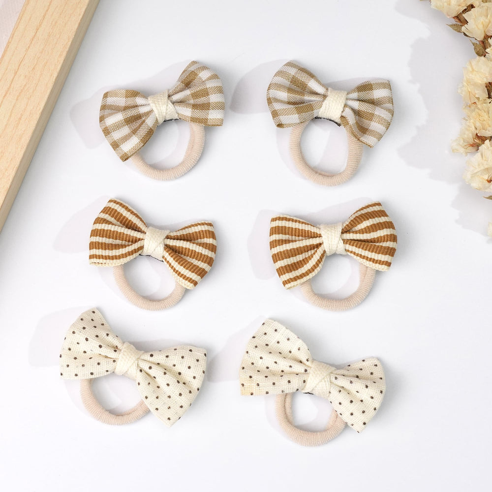 BBGifts Kahki baby hair accessory closeup shows flower bow and soft band.