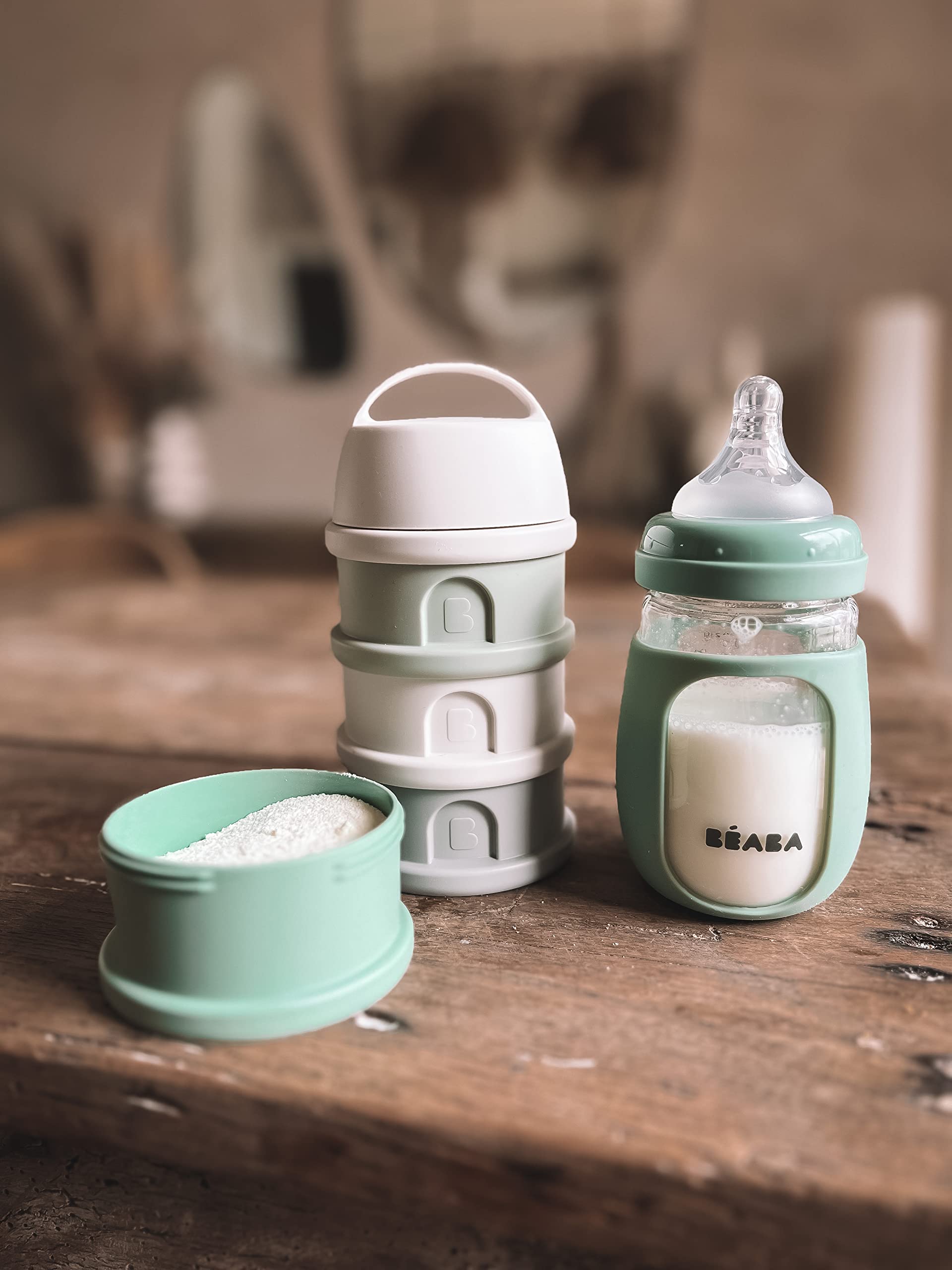 Beaba 7 oz glass bottle in Sage for on-the-go feeding with a secure grip.
