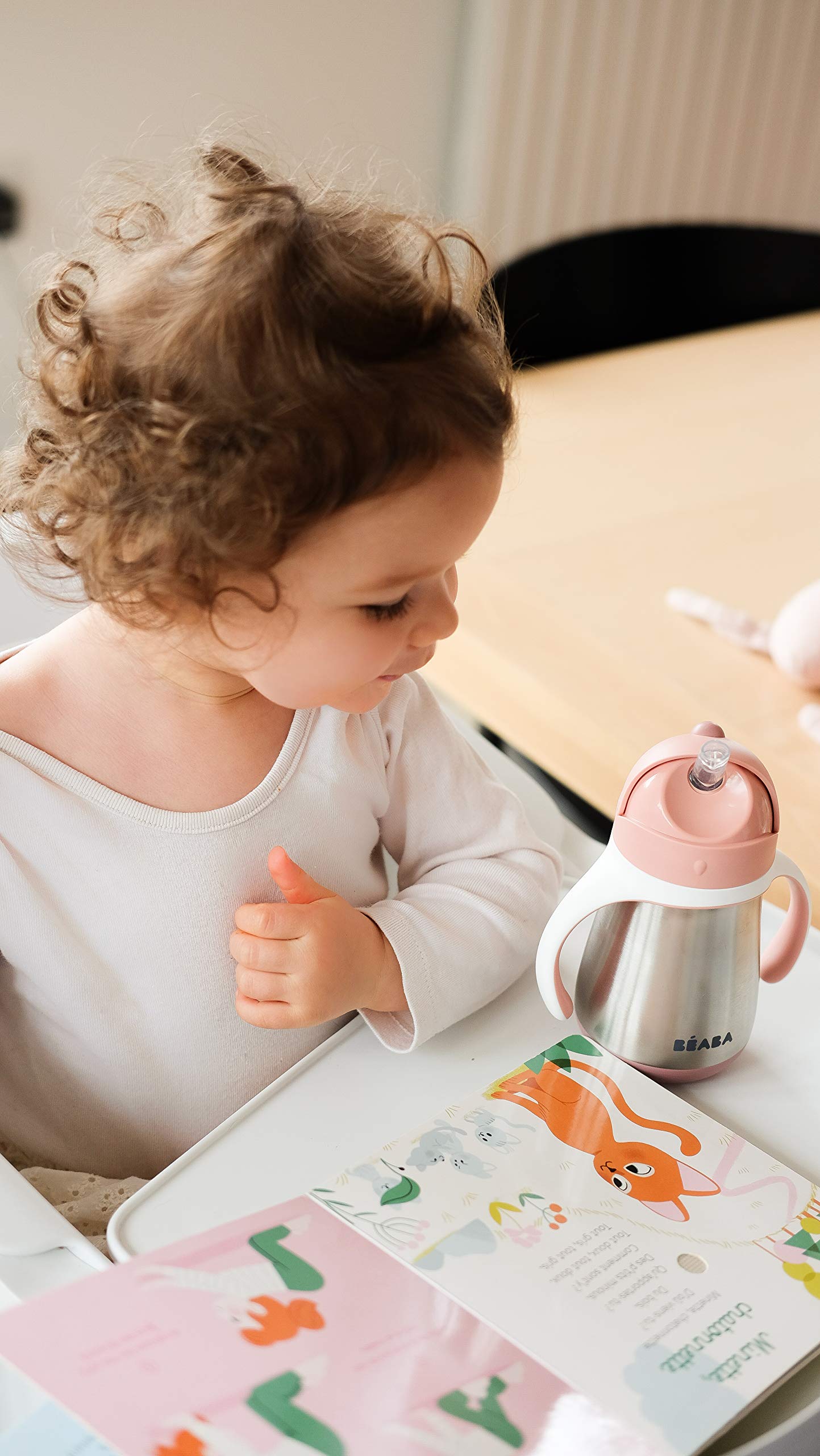 BEABA rose cup being held by child communicates ergonomic design and comfortable exterior