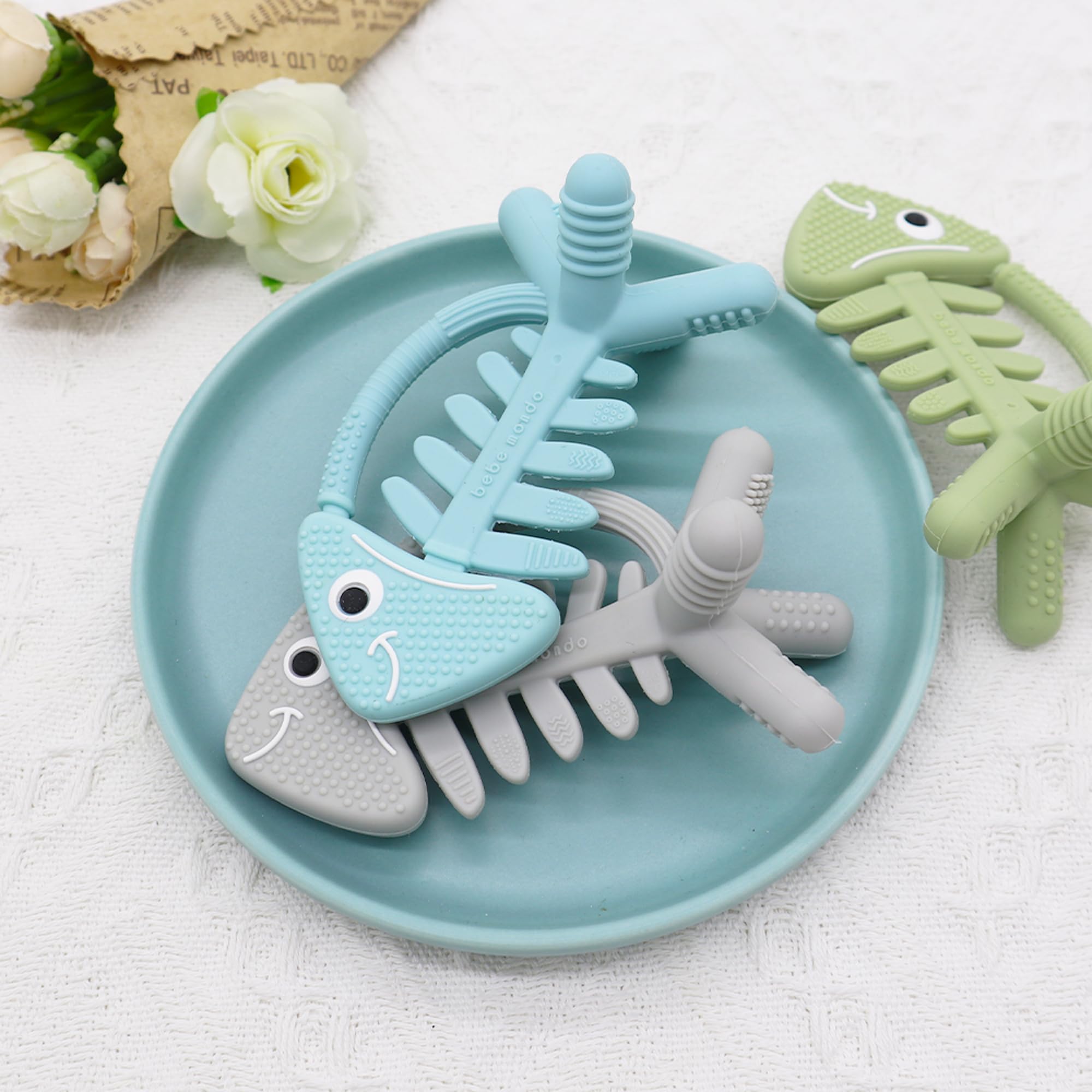 Bebe Mondo fish turquoise diaper-bag-friendly teether for travel.