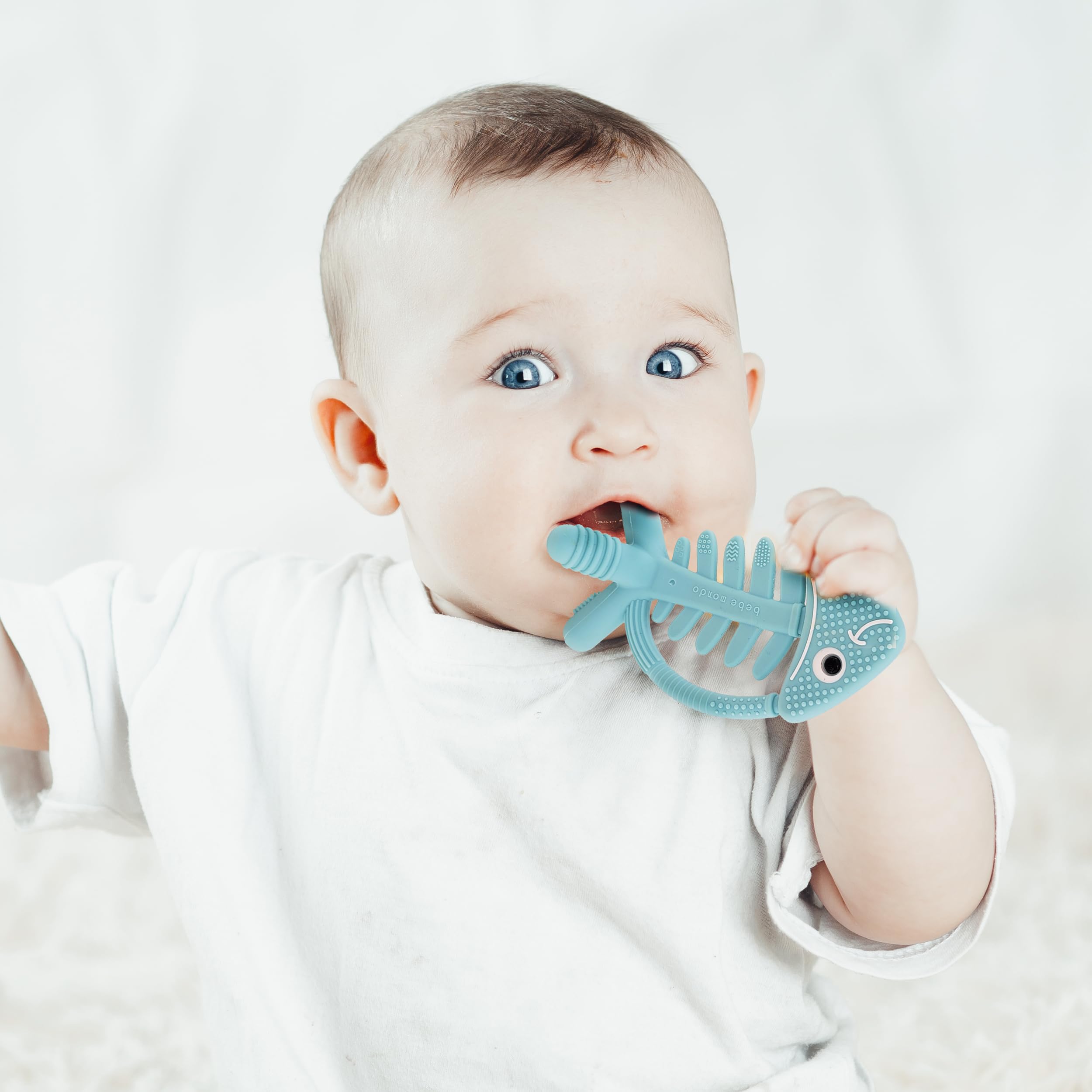 Bebe Mondo fish turquoise dishwasher-safe silicone for easy cleaning.