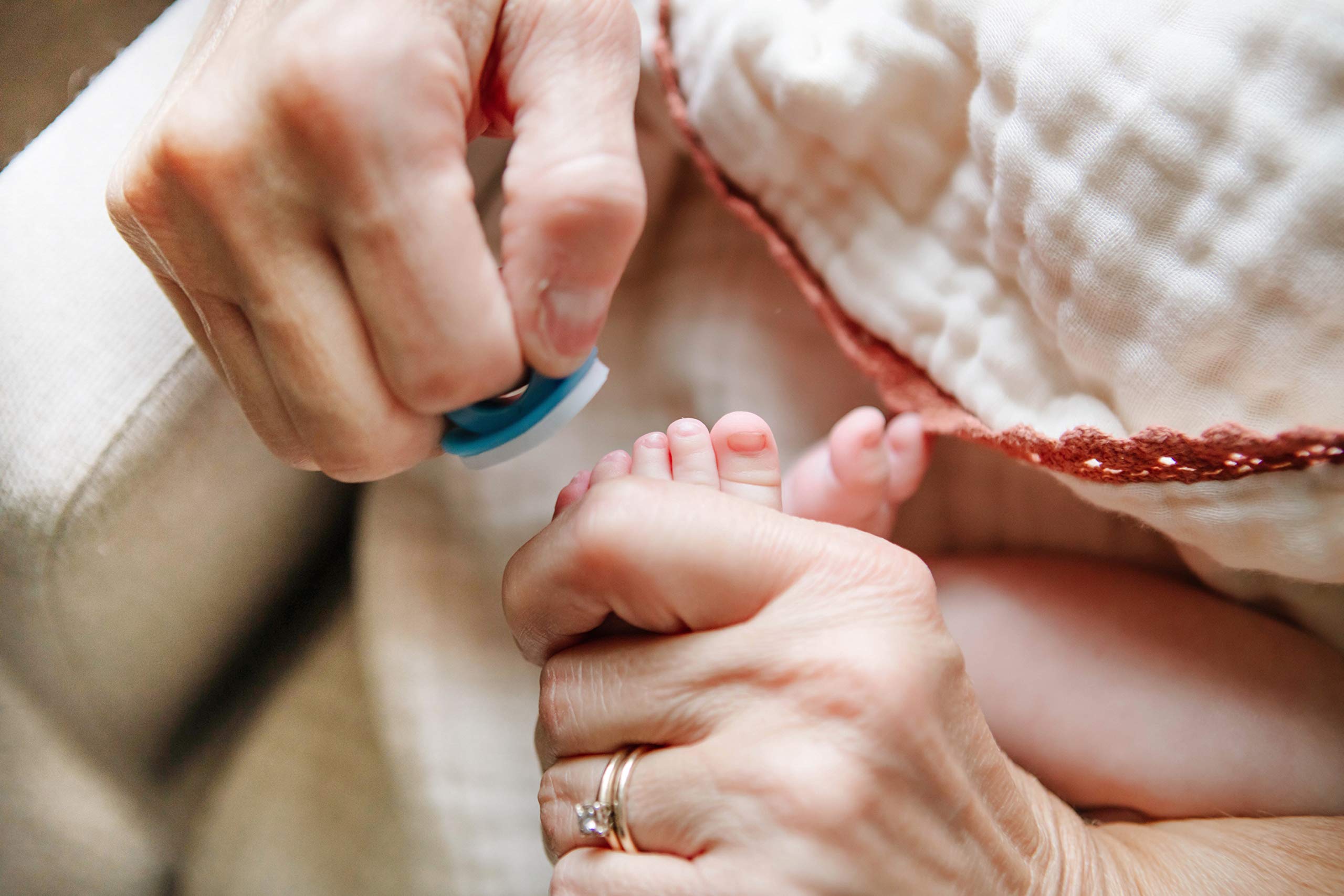 bebon ring with files in use on a baby's tiny nails.