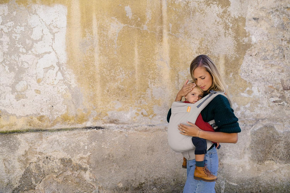 Beco backpack-style carrier in ecru supports hands-free family outings.