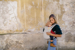 Beco backpack-style carrier in ecru supports hands-free family outings.