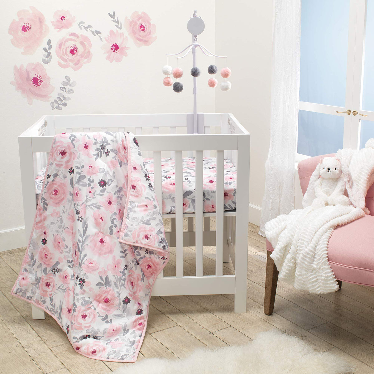 Bedtime Originals Blossom Pink Quilt closeup shows soft microfiber and vibrant color for cozy crib nights.