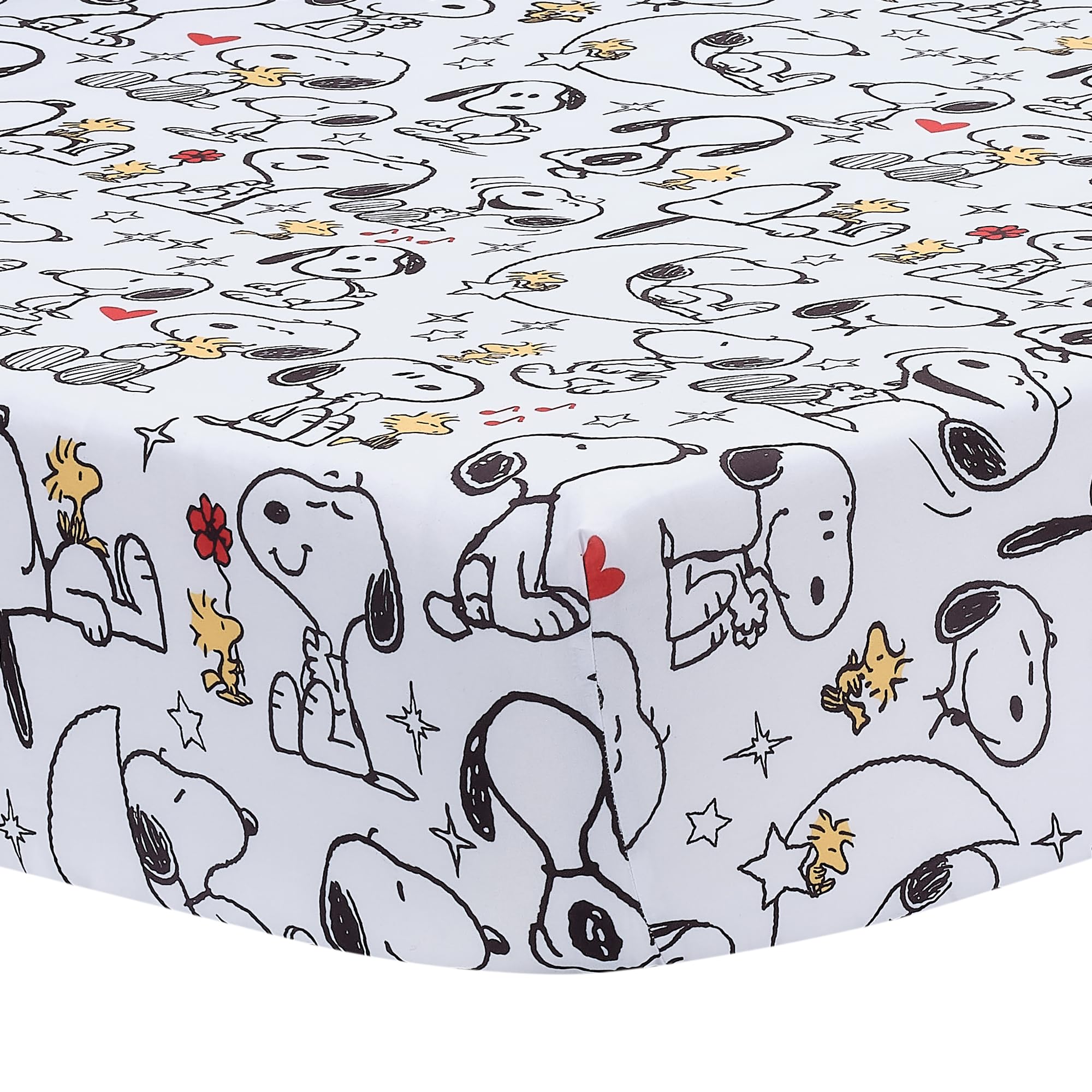 Bedtime Originals Snoopy Love crib skirt with Snoopy artwork accents the crib.