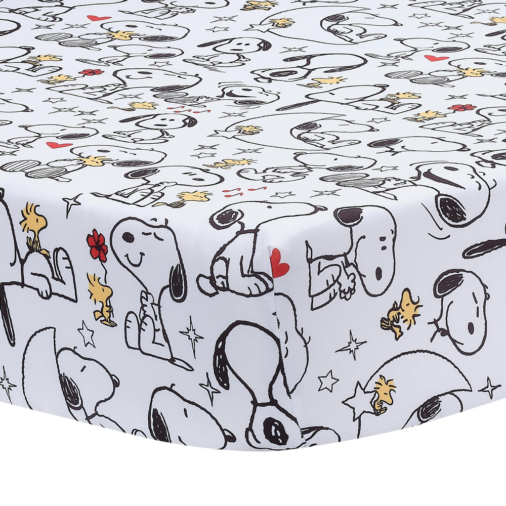 Bedtime Originals Snoopy Love crib skirt with Snoopy artwork accents the crib.