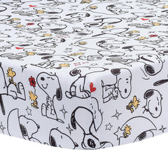 Bedtime Originals Snoopy Love crib skirt with Snoopy artwork accents the crib.