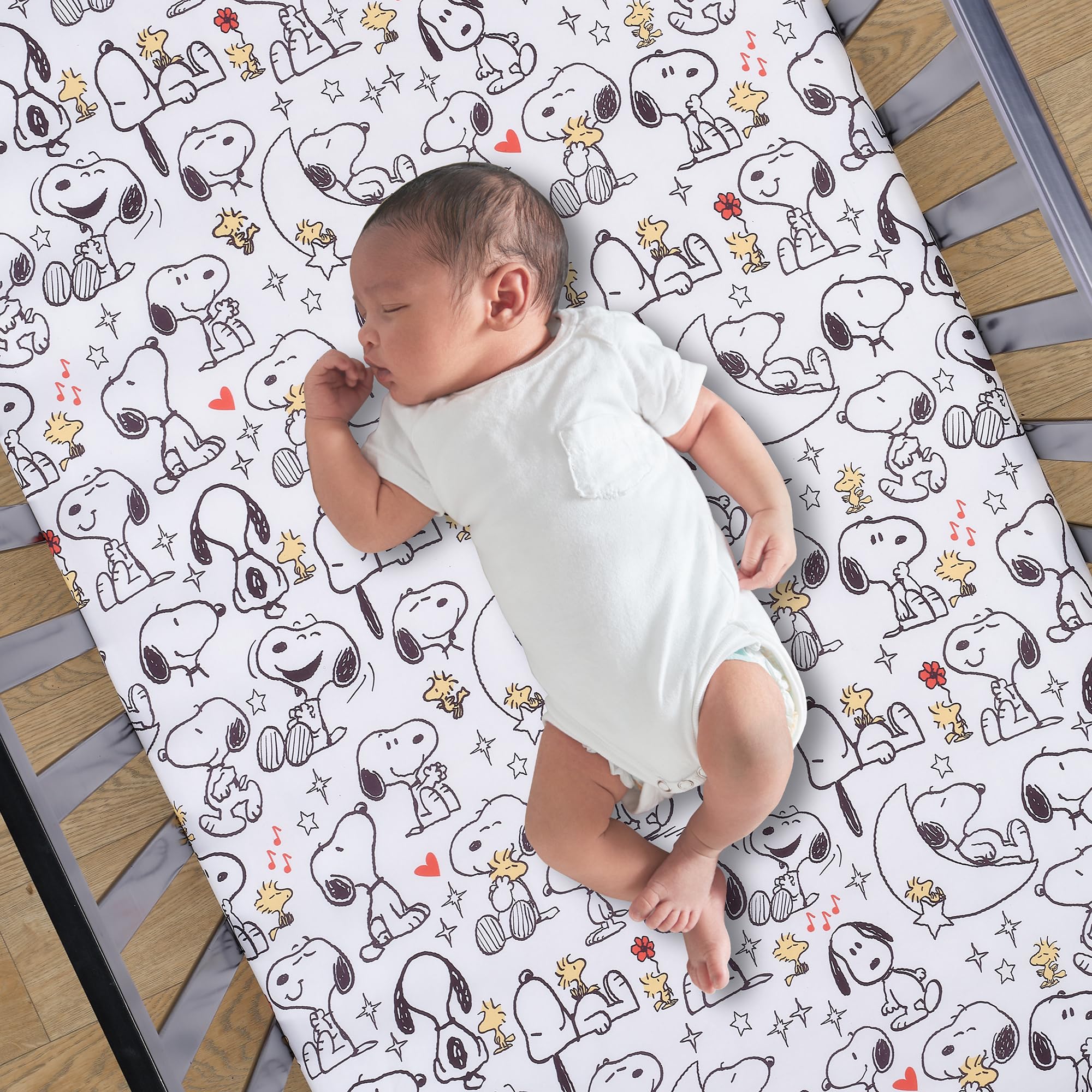 Bedtime Originals Snoopy Love nursery setup image showing coordinated Peanuts theme.