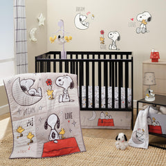 Bedtime Originals Snoopy Love quilt close-up with soft microfiber texture for gentle snuggling.