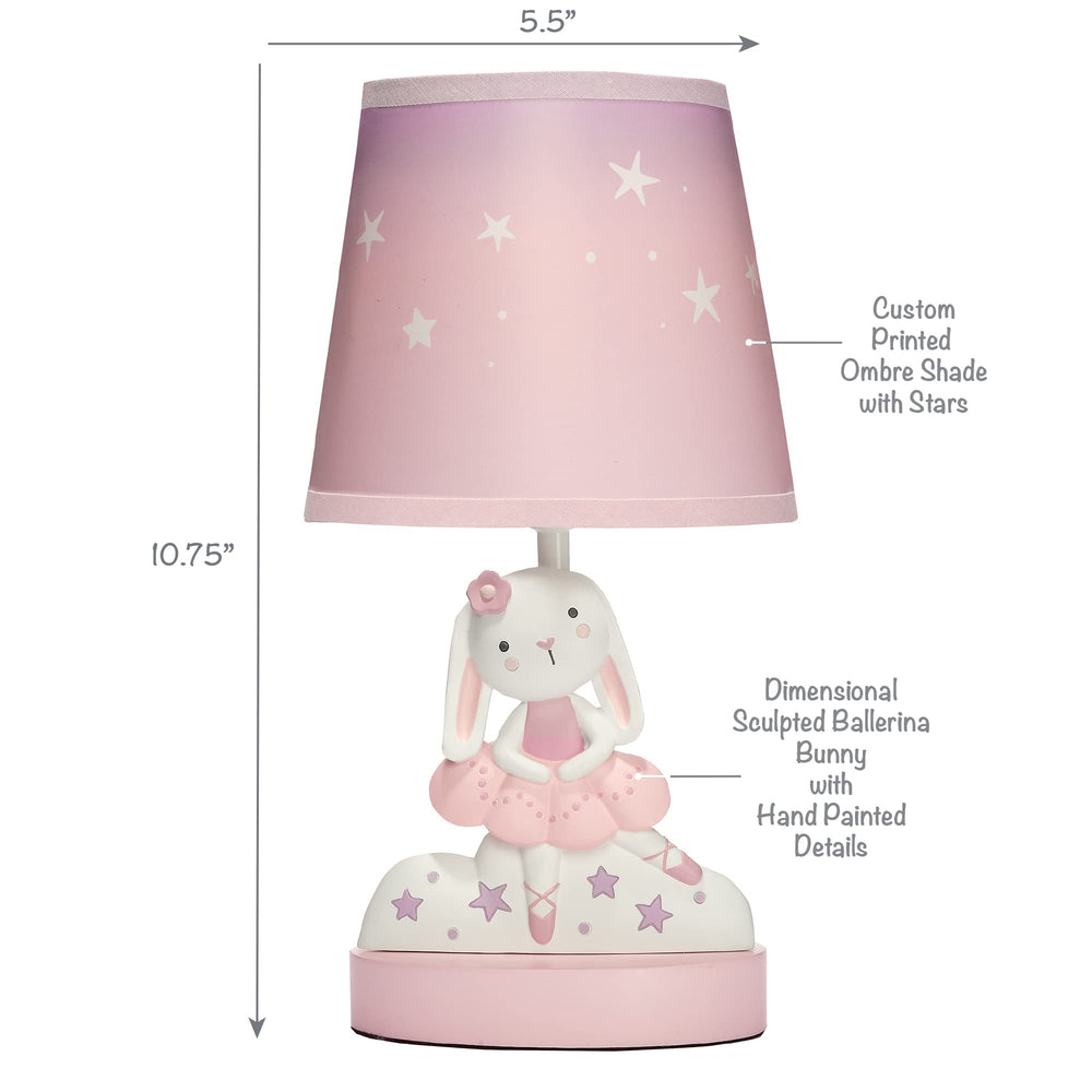 Bedtime Originals Tiny Dancer lamp lit in nursery shows gentle illumination for bedtime routines