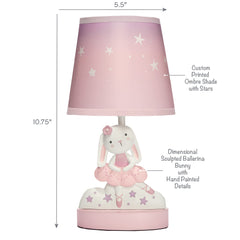 Bedtime Originals Tiny Dancer lamp lit in nursery shows gentle illumination for bedtime routines
