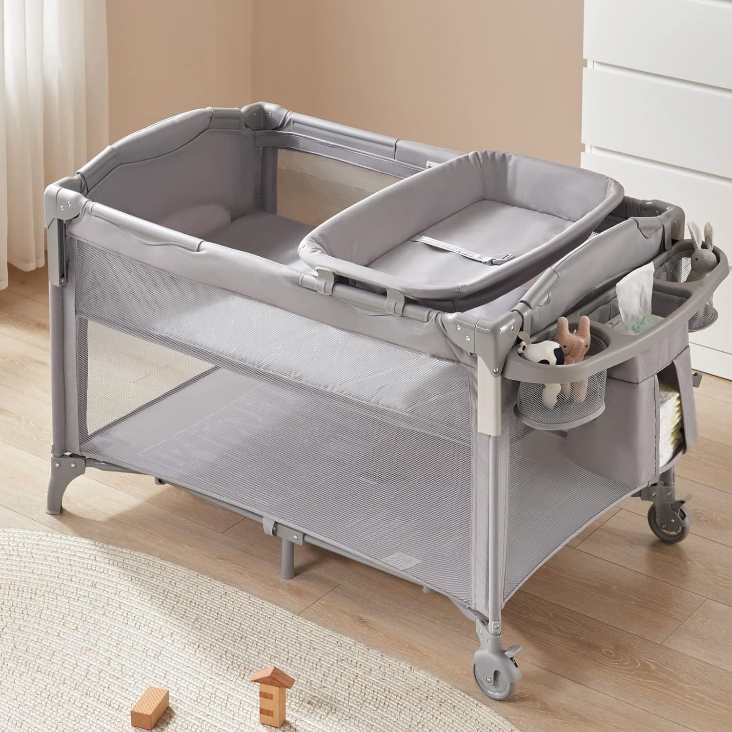 BEKA side storage pocket holding diapers and wipes within reach