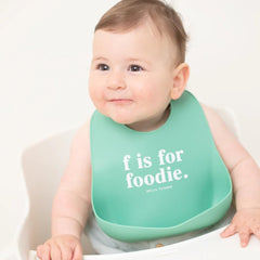 Bella Tunno bib food-catcher pocket-open traps crumbs to reduce mess.