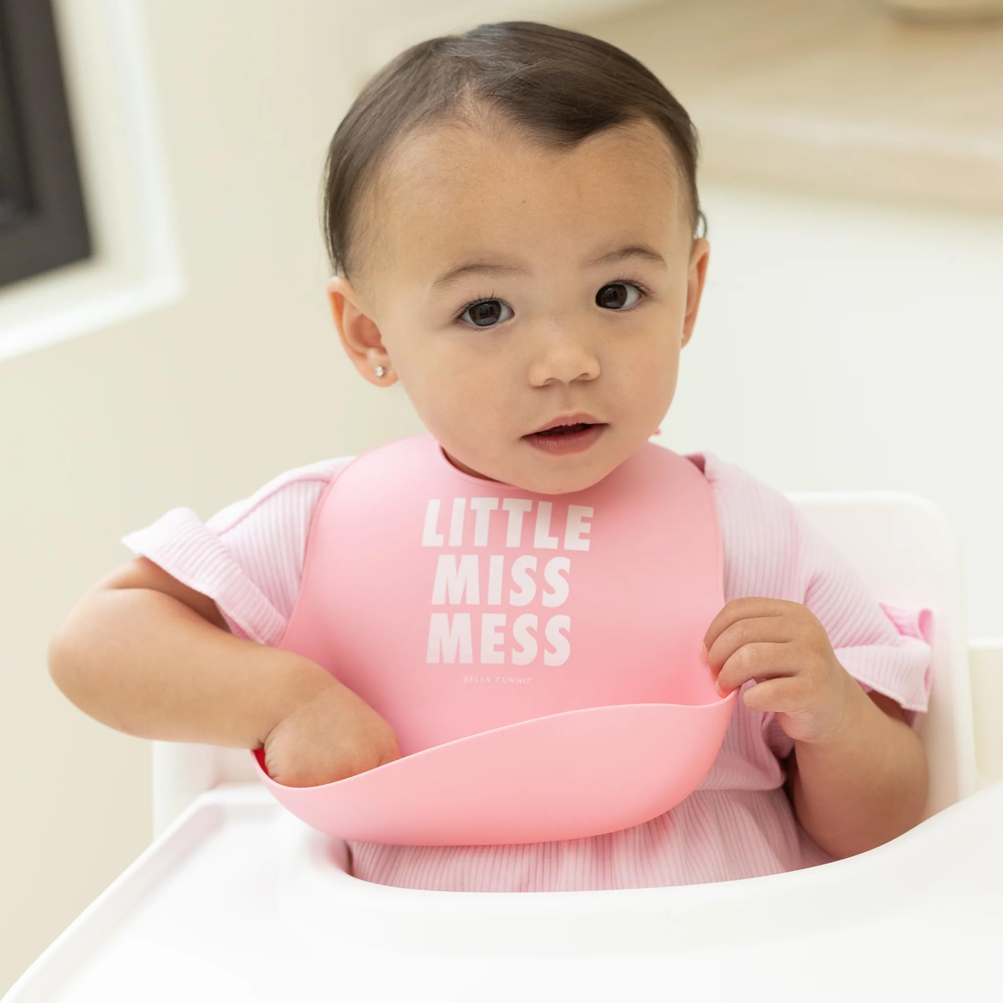 Bella Tunno Little Miss Mess bib pocket open catching drips during feeding.