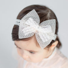 Bethynas baby bow-knot headband closeup shows delicate lace for gentle infant comfort