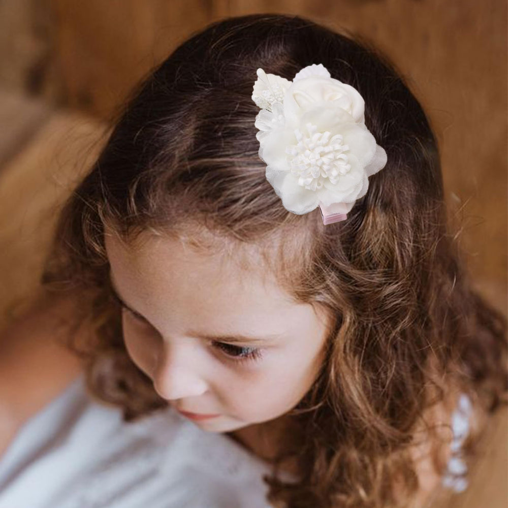 BFNAAgirl flower hair clip paired with party dress for photos.