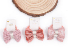 BIANHUAN solid-color bows with durable elastics for secure everyday wear.