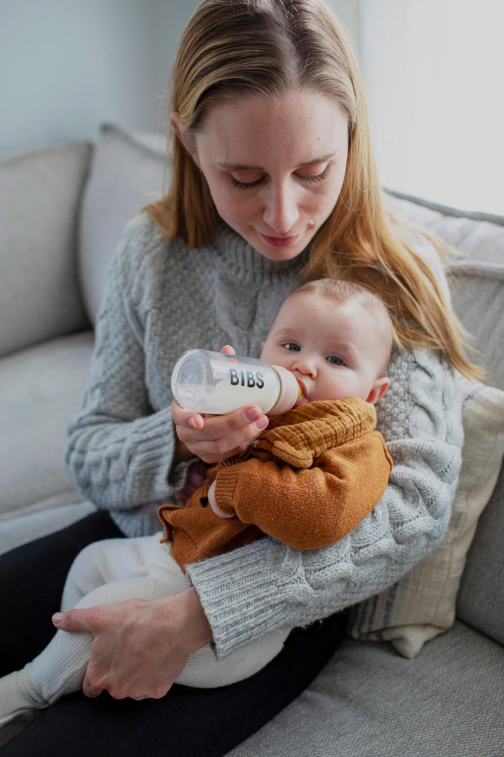 BIBS glass bottle close-up highlighting blush-cap design and secure grip.