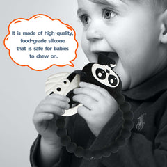 BIGSPINACH silicone Grim Reaper teether in hands demonstrates easy gripping for tiny fingers