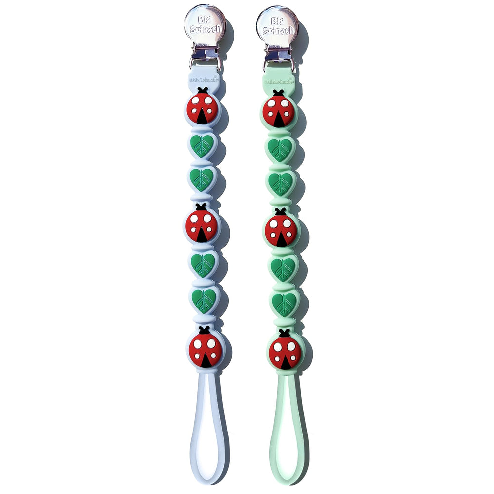 BIGSPINACH silicone pacifier clip closeup shows a secure clasp on baby clothes for on-the-go pacifier control.
