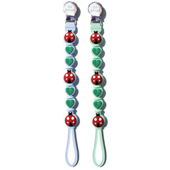 BIGSPINACH silicone pacifier clip closeup shows a secure clasp on baby clothes for on-the-go pacifier control.