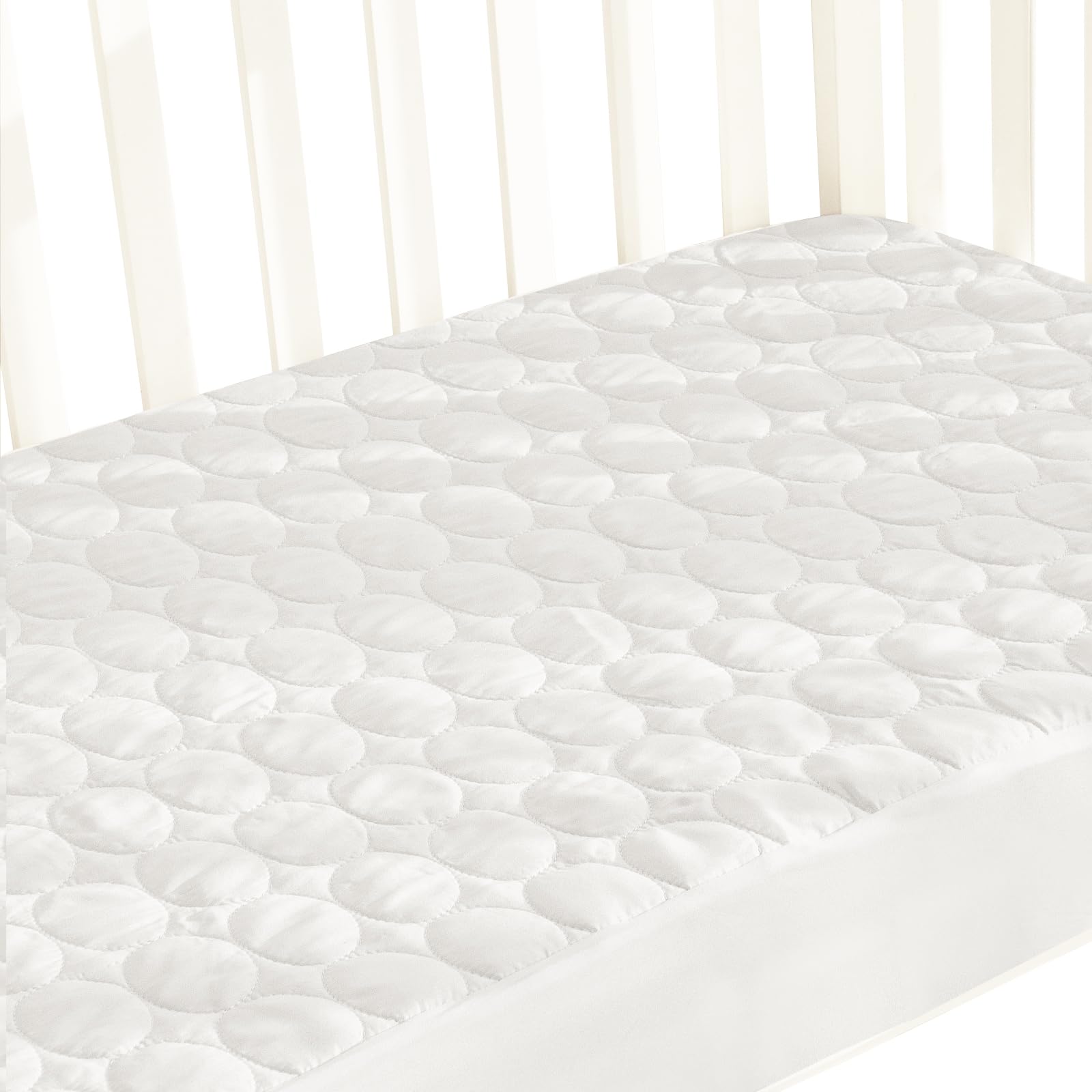 Biloban crib mattress protector on a standard mattress provides waterproof protection and a smooth sleeping surface.
