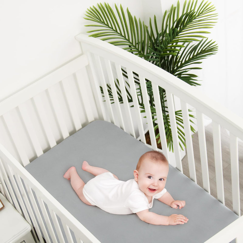 Biloban grey neutral crib sheets in modern nursery
