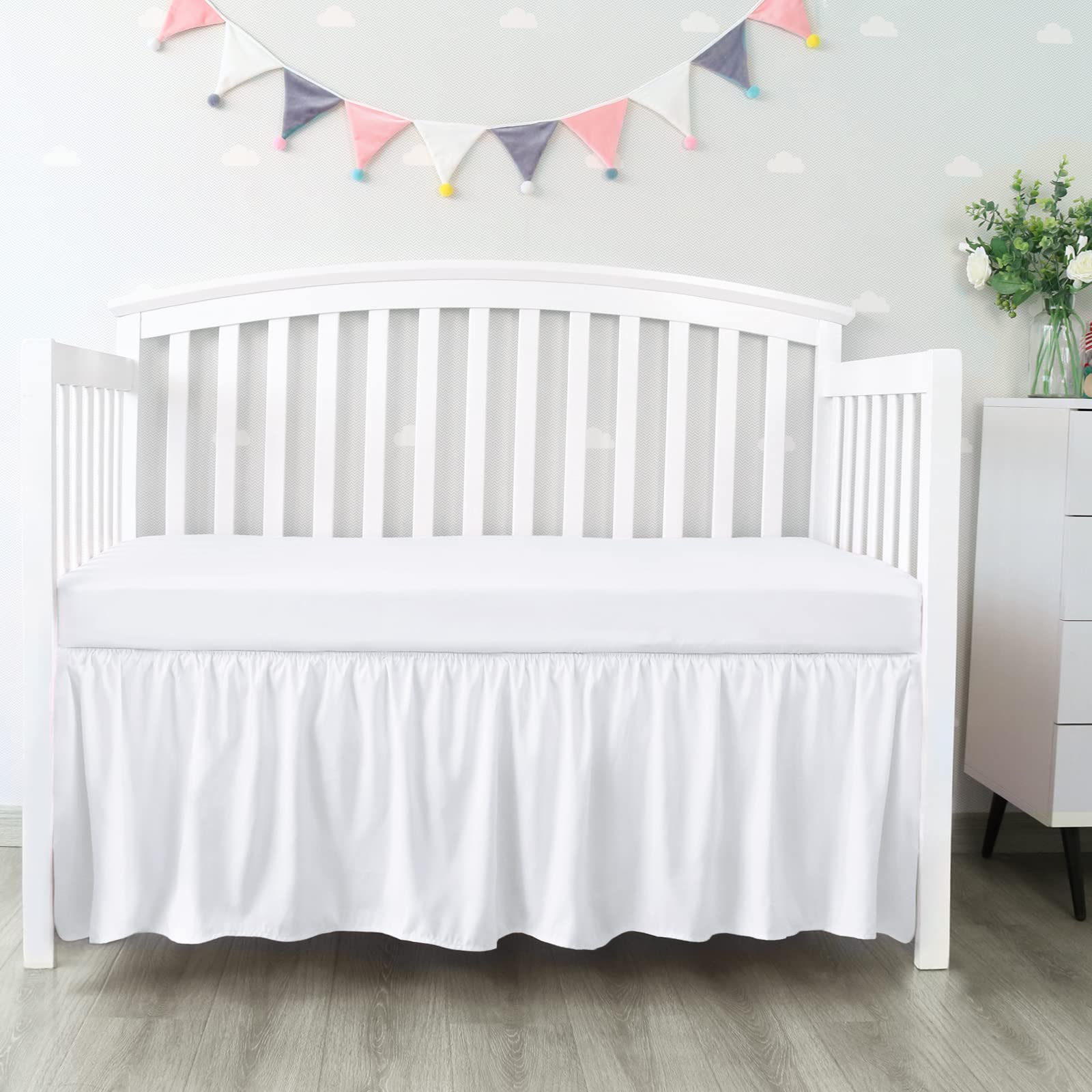 Biloban crib skirt 28x52 inches with 14-inch drop conceals under-bed storage neatly.