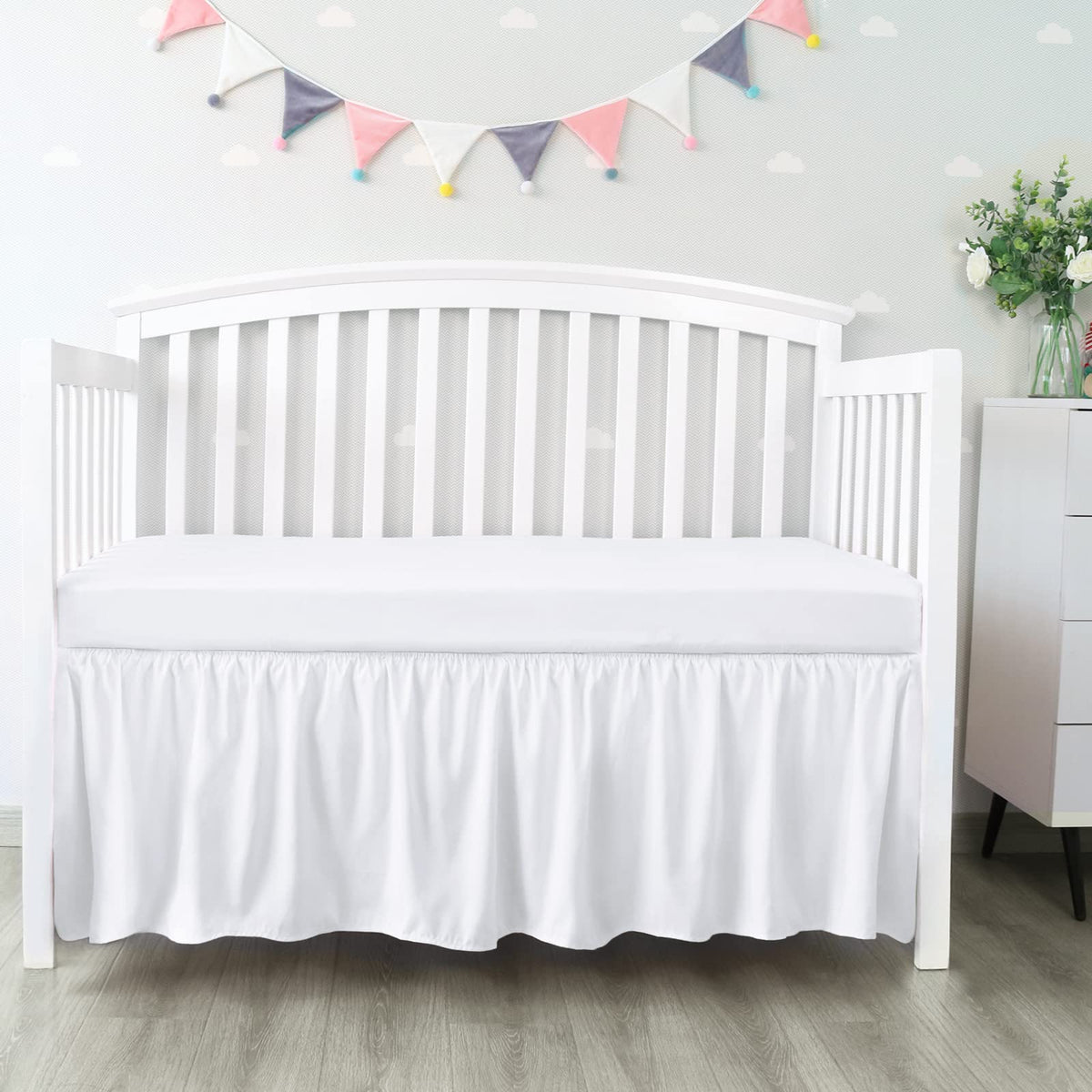 Biloban crib skirt 28x52 inches with 14-inch drop conceals under-bed storage neatly.