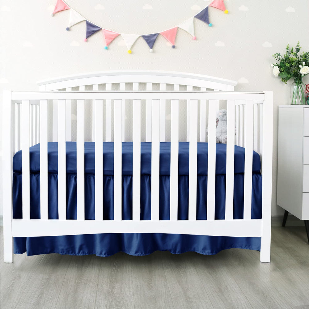Biloban navy crib skirt corner buttons ensure secure fit