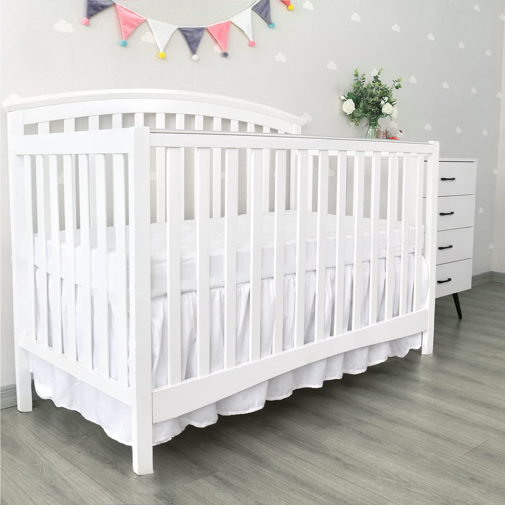 Biloban easy-on-off crib skirt with elastic straps for quick setup.