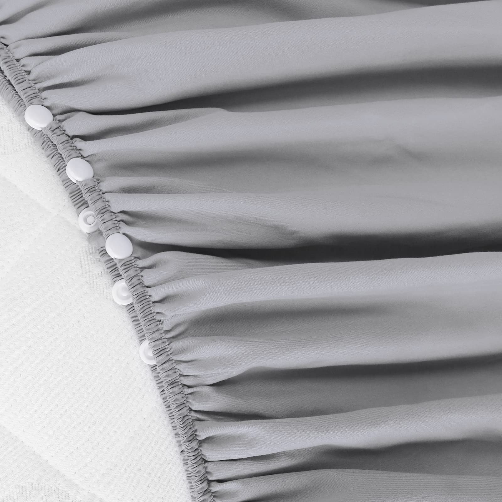 Biloban crib skirt grey side view highlights wrap-around design for secure fit