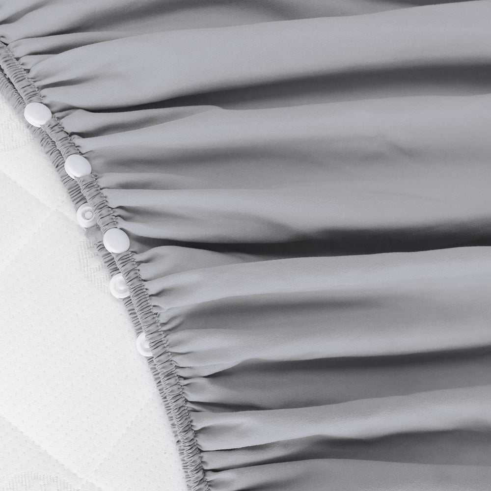 Biloban crib skirt grey side view highlights wrap-around design for secure fit